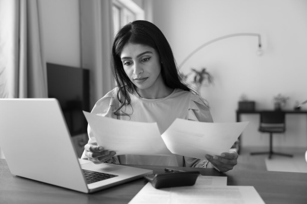 Woman reviewing IVF costs and treatment plans, exploring cost-effective options made possible with a hand carry IVF courier