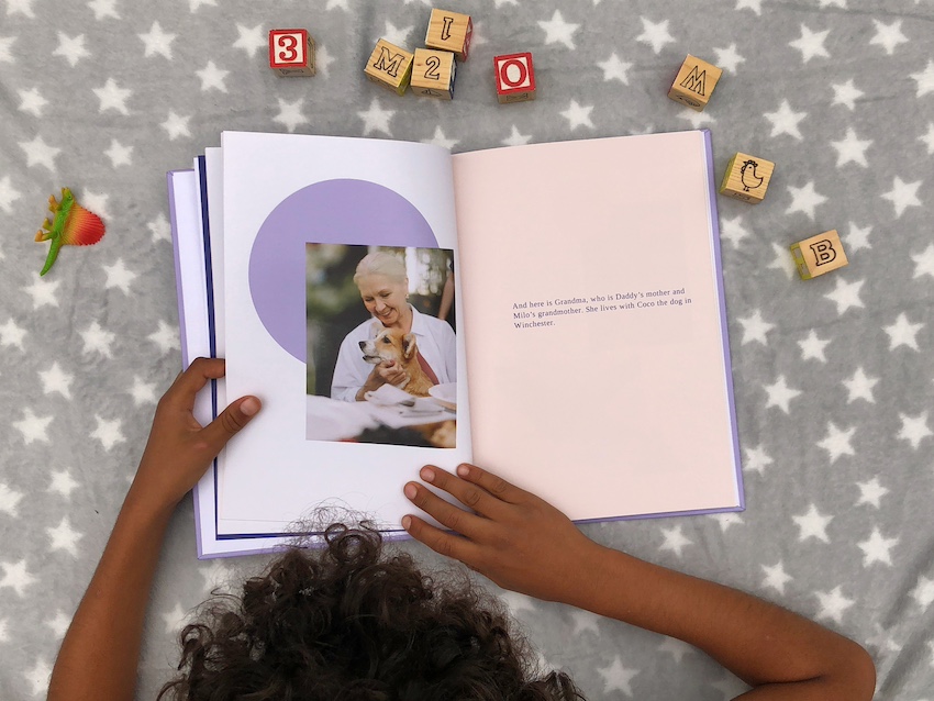 Child laying on a blanket reading his Storydo book, demonstrating how it can build identity and connection