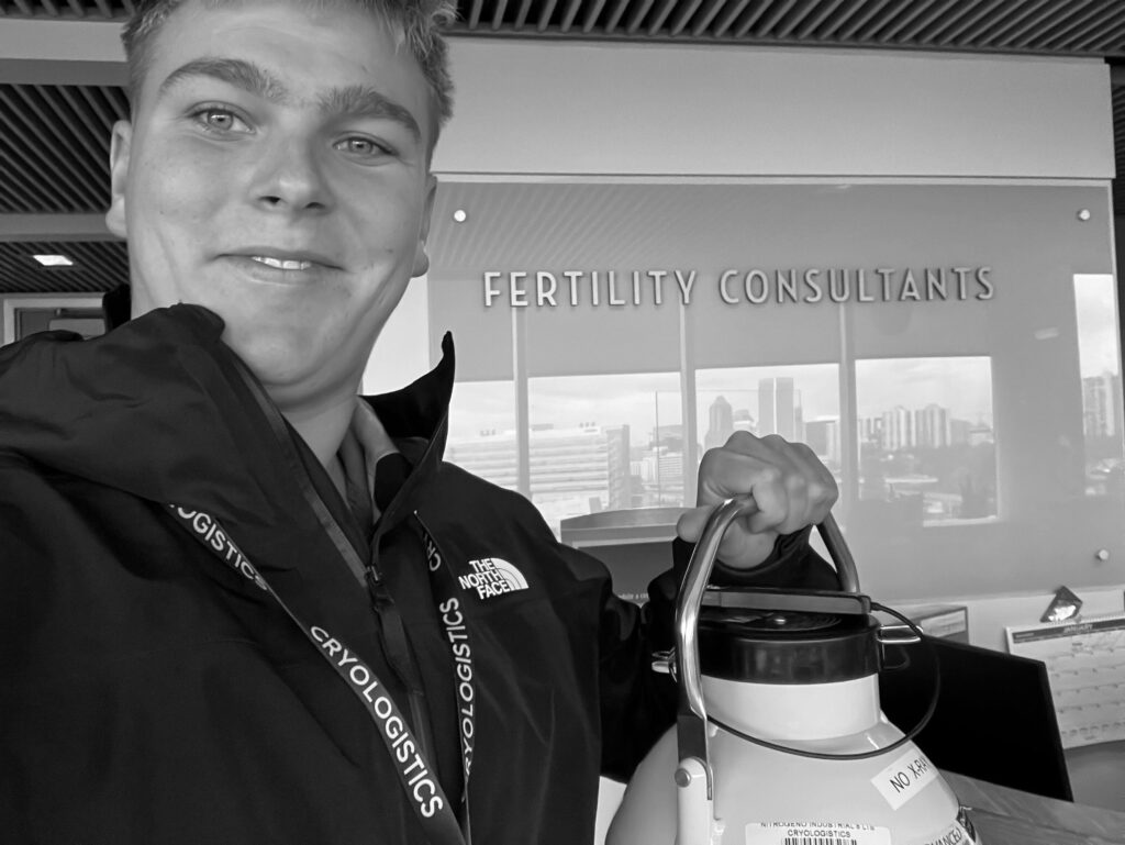 CryoLogistics medical courier holding a cryoshipper at a fertility clinic, demonstrating how to transport sperm samples for IVF safely
