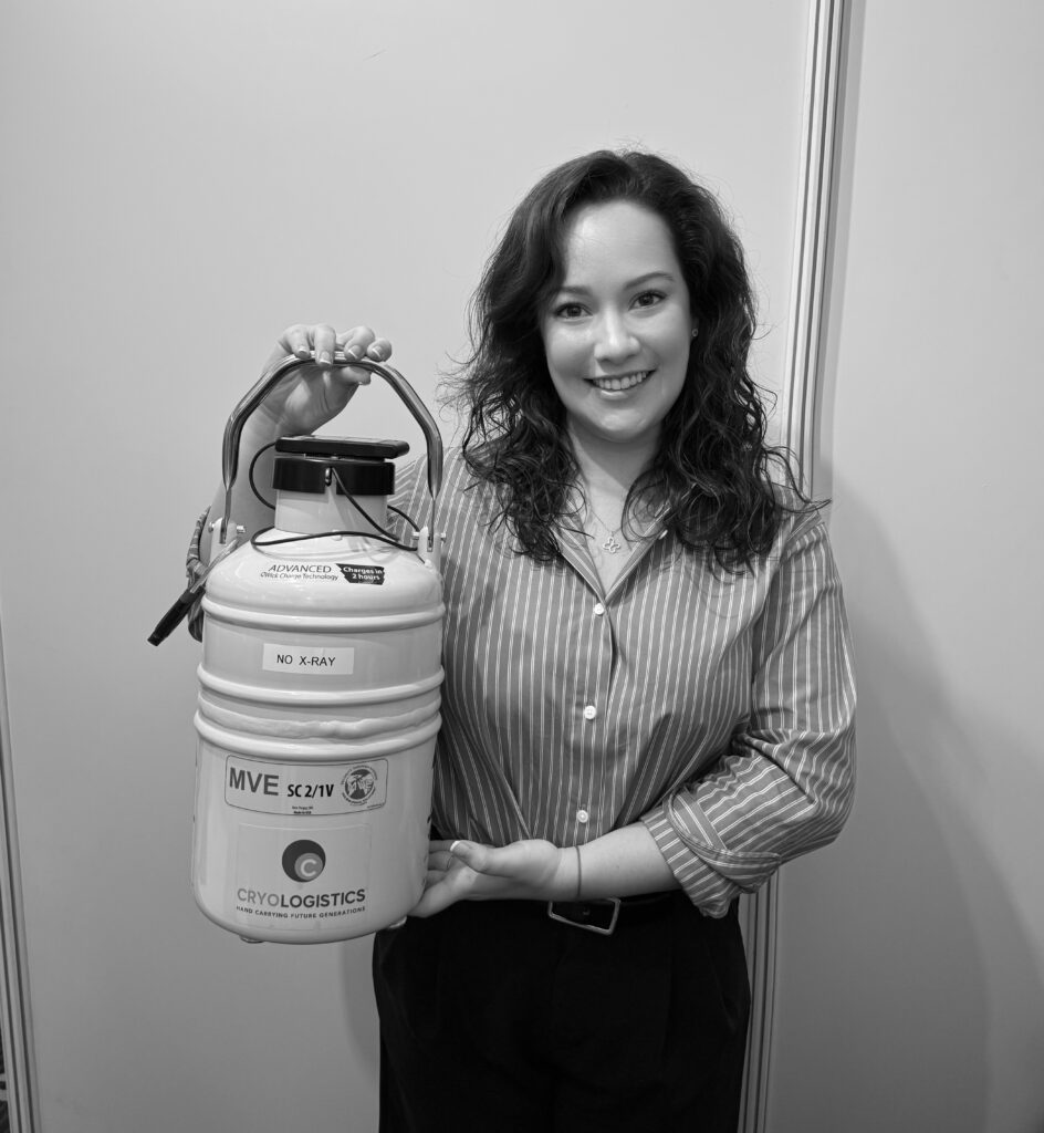 CryoLogistics medical courier holding a cryoshipper used to safely store and transport embryos