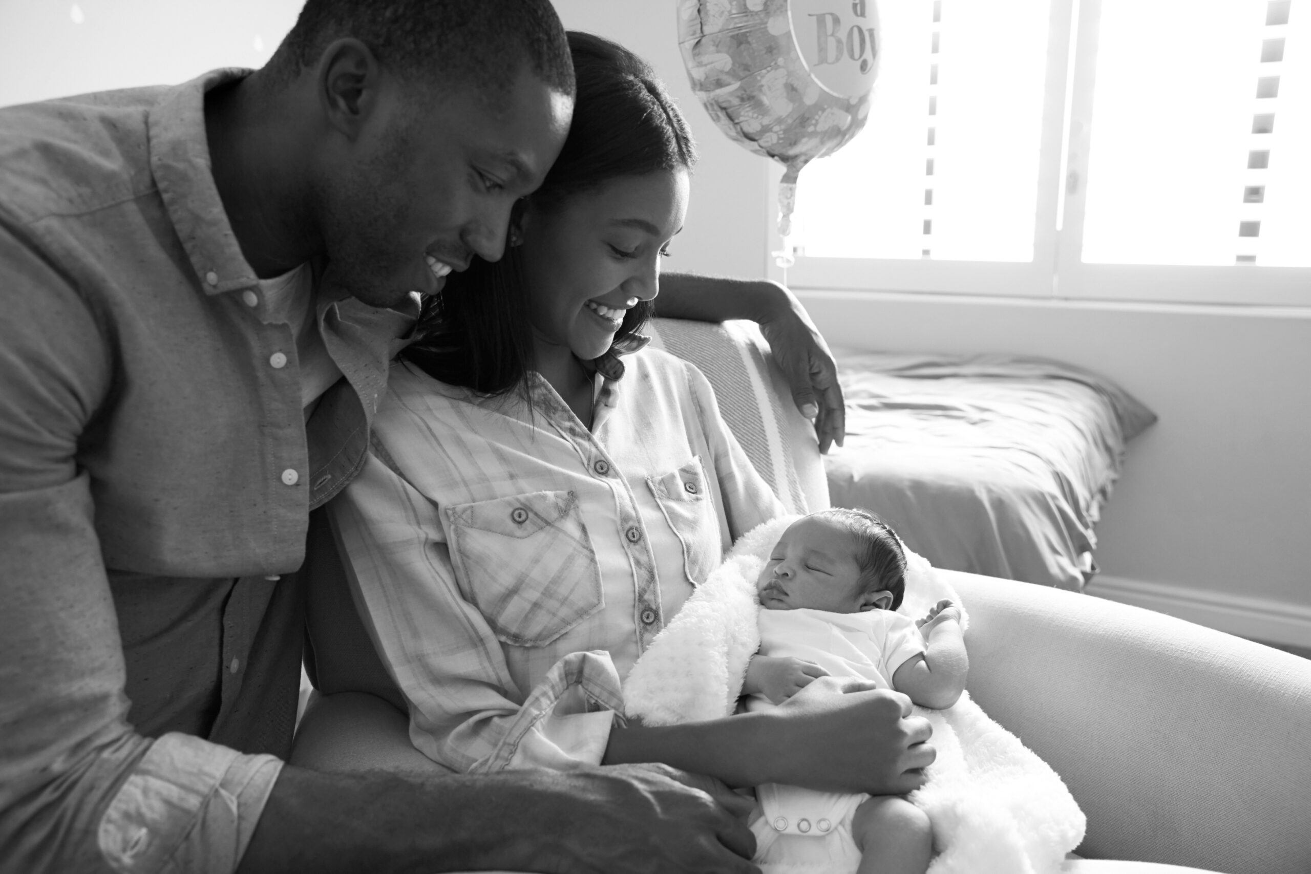 New parents holding their newborn at home after completing IVF abroad
