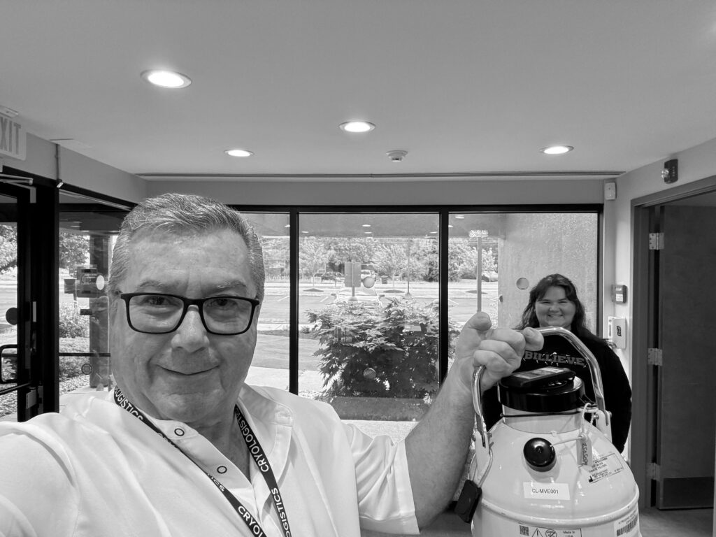 IVF courier hand-carrying a cryoshipper, showing the safest way to transfer embryos to another clinic